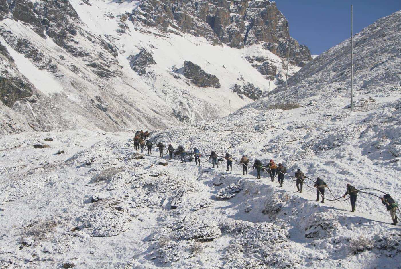 A line of trekkers making their way through Thorong La pass