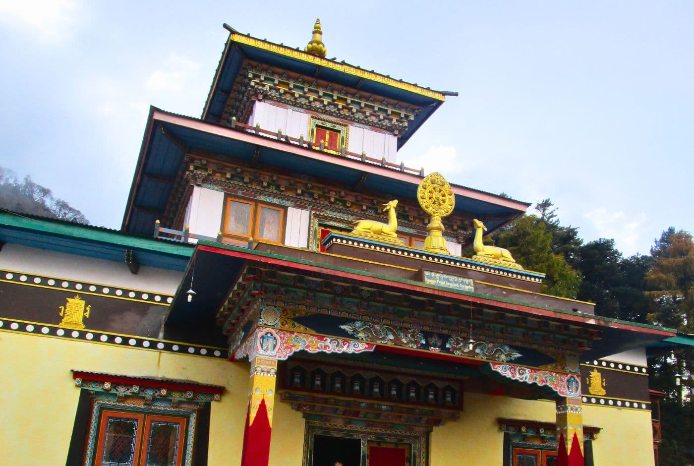 Buddhist temple in Tsum Valley, Nepal with colorful designs, golden statues, and detailed decoration