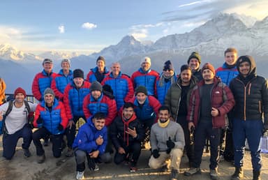 Group of hikers posing with snowy mountains of Annapurna - ABC trek